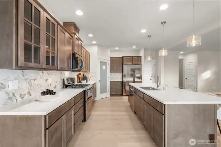 Full tile backsplash with gas range.