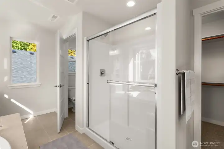 Step in shower with water closet.