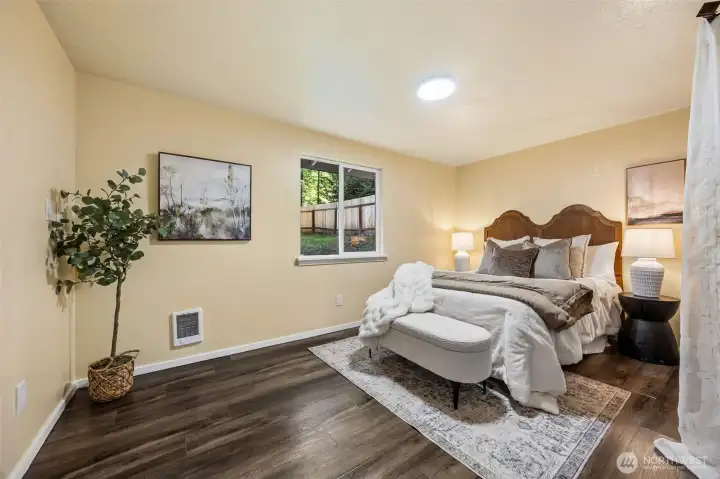 The primary bedroom has a view of the back yard.
