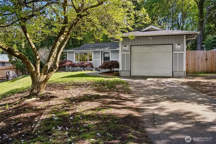 One car garage, with more uncovered parking to the right.