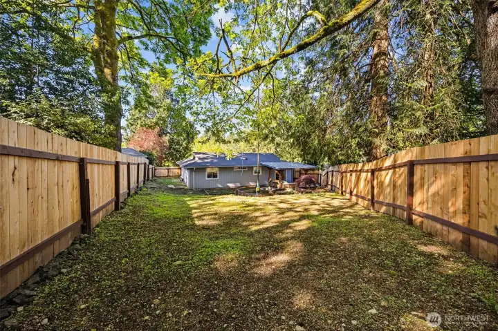 Fully fenced yard with rope swing. Perfect for play, pets and gardening!