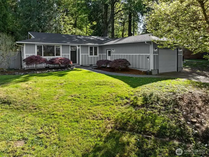 The front lawn gently rolls to the fence.
