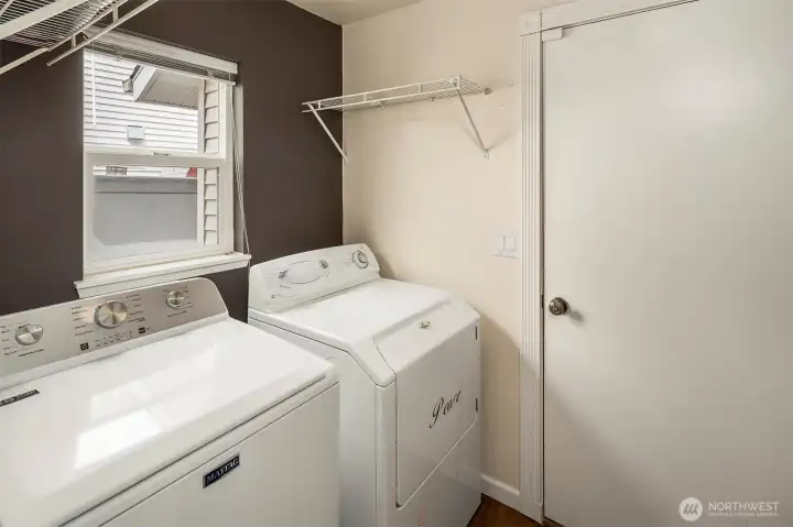 Indoor laundry room with door to garage.