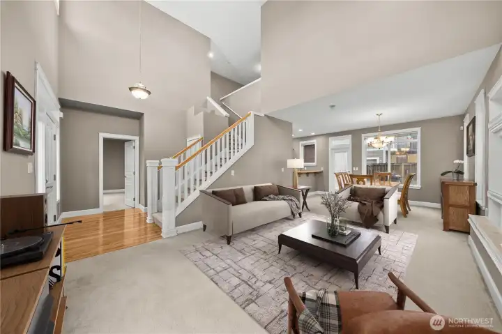 Light-filled living room with soaring ceilings, tall windows, and a cozy gas fireplace. The open-concept layout creates a bright, airy feel and connects beautifully to the dining area. Light-filled living room with soaring ceilings, tall windows, and a cozy gas fireplace. The open-concept layout creates a bright, airy feel and connects beautifully to the dining area.