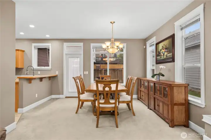 Light-filled dining area with generous windows, a warm and inviting atmosphere, and seamless access to the backyard. Conveniently located next to the kitchen, it offers a comfortable setting for everyday dining and gatherings. Light-filled dining area with generous windows, a warm and inviting atmosphere, and seamless access to the backyard. Conveniently located next to the kitchen, it offers a comfortable setting for everyday dining and gatherings.