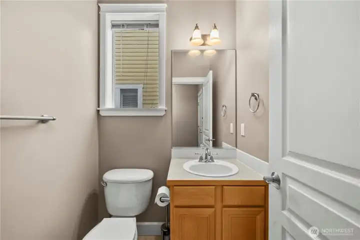 Bright and convenient main-level half bath with a clean, simple design, natural light, and easy access for guests. Bright and convenient main-level half bath with a clean, simple design, natural light, and easy access for guests.