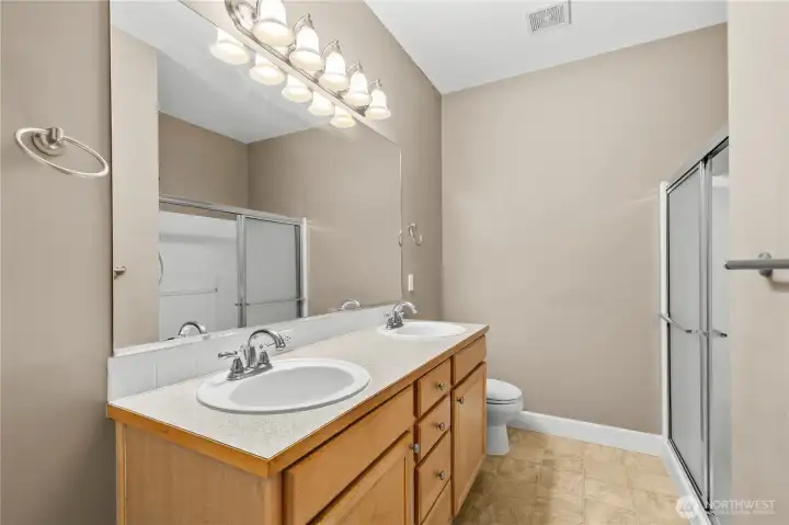Well-appointed primary bathroom with dual sinks, ample vanity space, and a walk-in shower, offering both comfort and practicality in the primary suite. Well-appointed primary bathroom with dual sinks, ample vanity space, and a walk-in shower, offering both comfort and practicality in the primary suite.