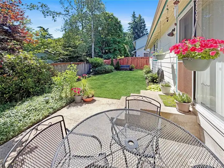Charming patio just off of great room. Private with views of mature landscaping.