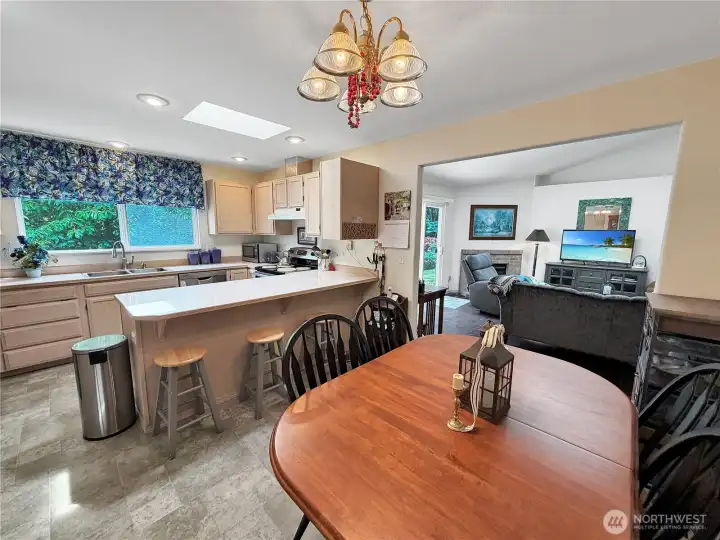 Kitchen dining view, large window over sink offers view of lovely yard.  Large bar provides additional seating.