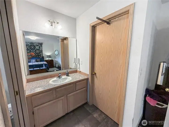 Primary vanity looking towards walk-in closet to the right.