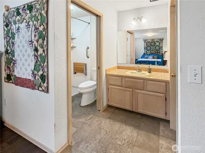View of Primary vanity, separate shower and toilet room with pocket door.