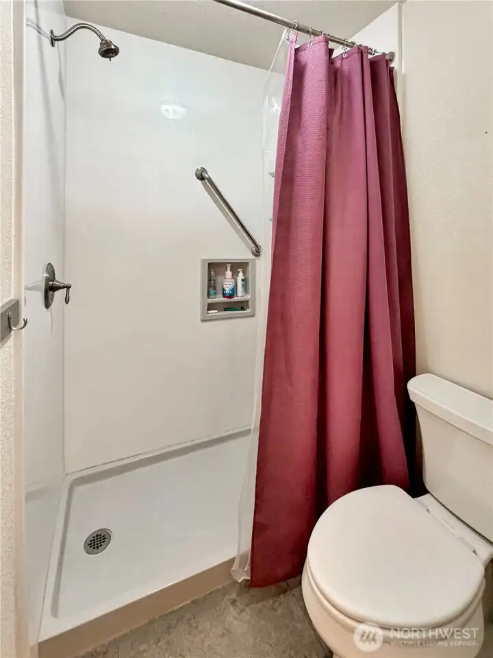 Updated walk-in shower with grab bars and seat.