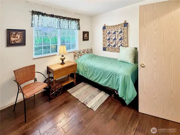 Bedroom 2 with more wood floors.