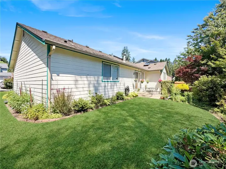 Rear view of home and side yard.