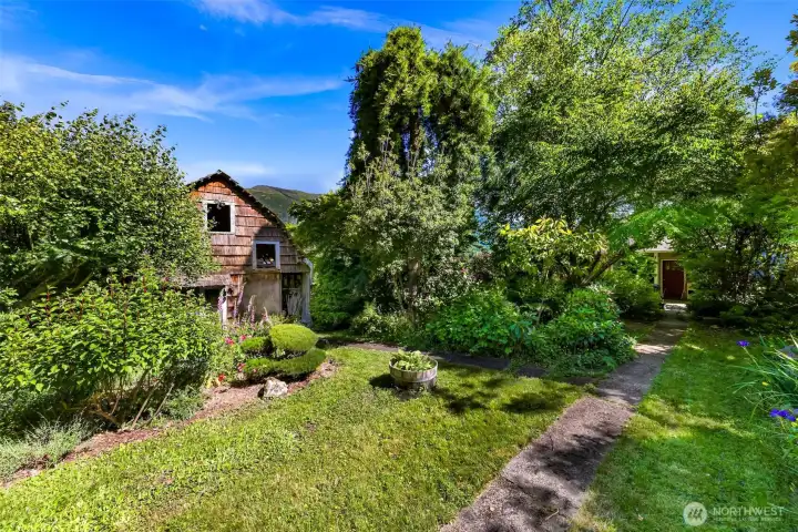 Walkway to the entrance passes by some of the beautiful gardens and rustic mini-barn.