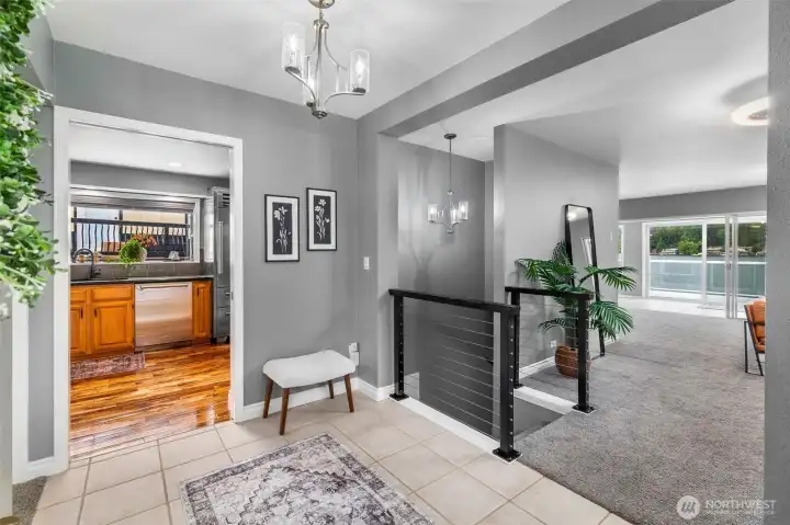 Light-Filled Entry Featuring Custom Iron Railing