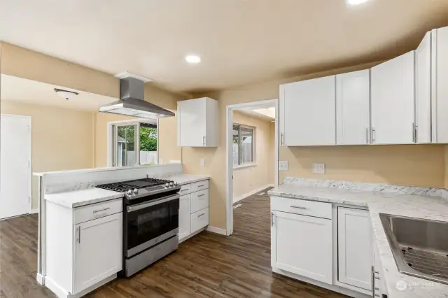 Fresh and ready for your next culinary adventures, this fully updated kitchen features a gas range with grill and classic Shaker style front cabinetry.