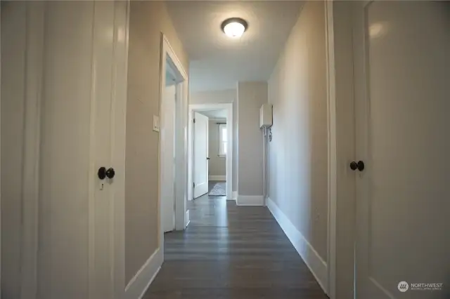 Top -  bedroom #1 with walk in closet behind the couch.