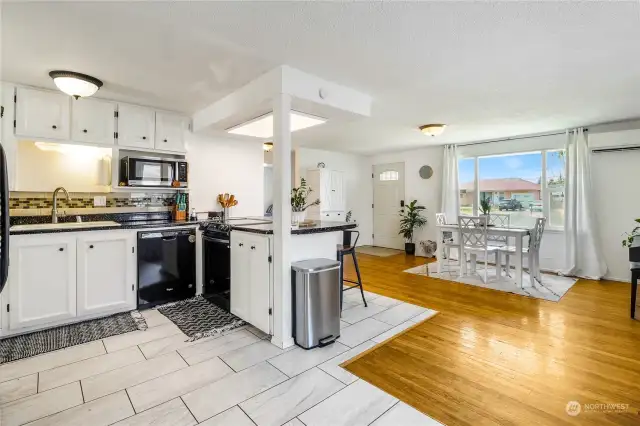 You'll appreciate the seamless flow of open space, gracefully extending from the kitchen to the dining area.