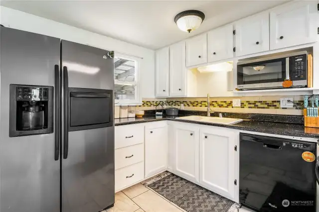 All appliances are included: a sleek stainless steel refrigerator with a convenient drawer to peek in and save on electricity, along with a dishwasher, microwave, and a brand new oven/range.