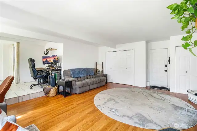 Another view of the family room, with hardwood flooring, a couple of closets and behind you here is the fireplace.  Notice the step down from the tile flooring.