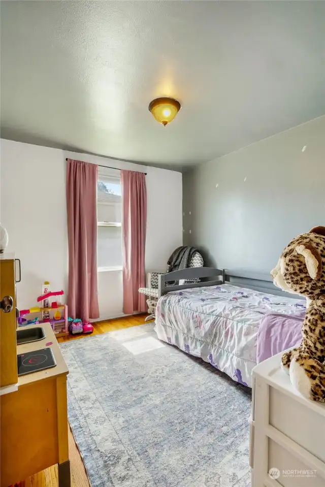 The second bedroom also has hardwood flooring with plenty of natural light. This bedroom is between the other two.