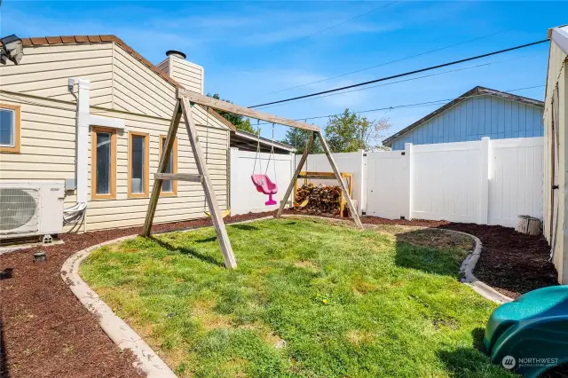 The back yard is fully fenced with six-foot high vinyl fencing, providing security and privacy, with plenty of room for littles to play. To the left is the new HVAC system which is connected to the three-zone heating/cooling system.