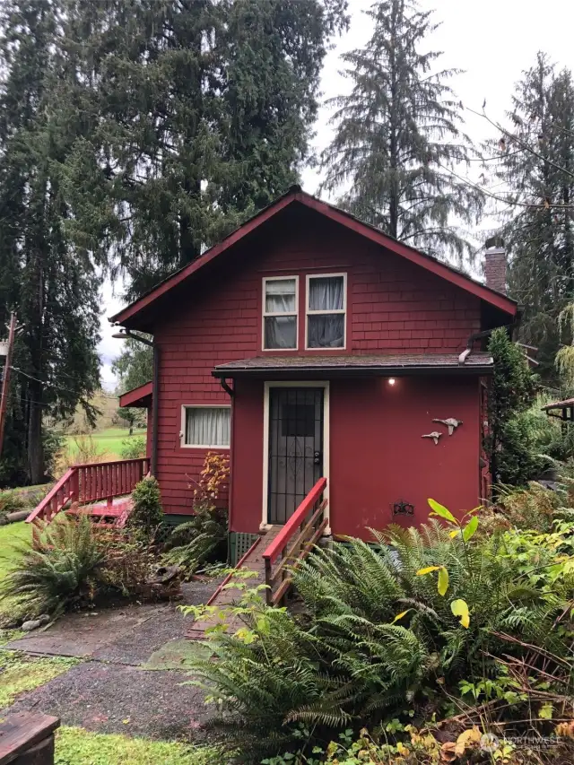 Front covered deck and side entry porch/utility room.