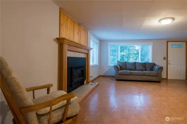 Large living room with fireplace and it opens up to the front deck and front yard