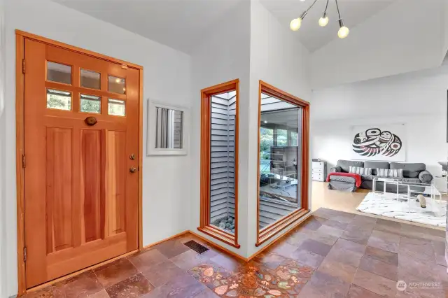 Vast and stylish entryway, with atrium. Large coats closet not visible here (on the right of the picture).