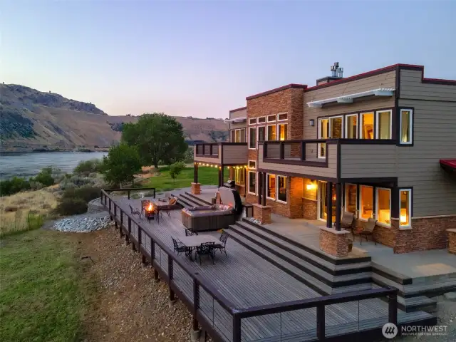 Exterior twilight view 1 of home w/ decks and outdoor living areas.