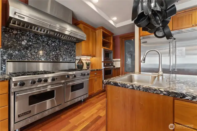 Kitchen view 1 w/ Viking® Professional appliances, wood cabinetry, walk-in pantry and granite countertops.