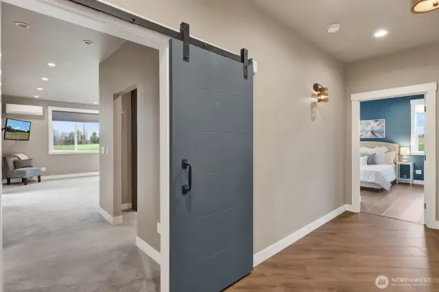 The large primary entrance welcomes you in with its barn door statement. Also highlighted here, you can really see how wide the hallways are specifically designed to accommodate ADA accessibility if needed.