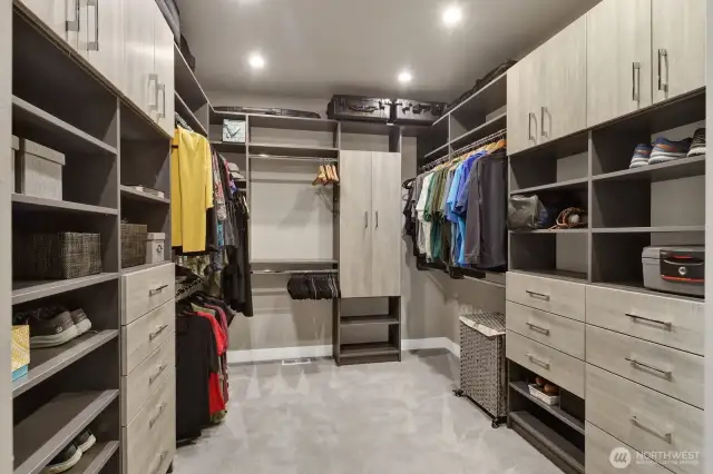 Wow! Check out the stunning custom-built storage found in this spacious primary walk-in closet designed to keep your whole wardrobe perfectly organized. With so much space, there's even enough room to add a center bench.