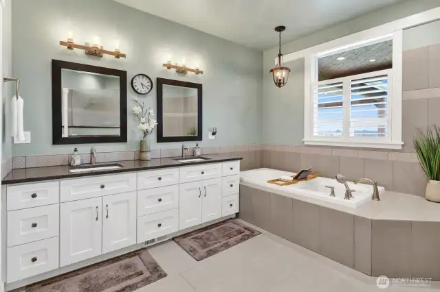Walking into this spacious and spa-like primary bathroom will make you want to stay awhile with the welcoming of the heated floors and generous no-step walk-in shower. It’s like you’re at your own resort!