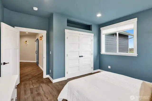 Bedroom #2 features additional storage space above the closet, along with beautifully hand-selected solid core doors that elevate the home's overall style.