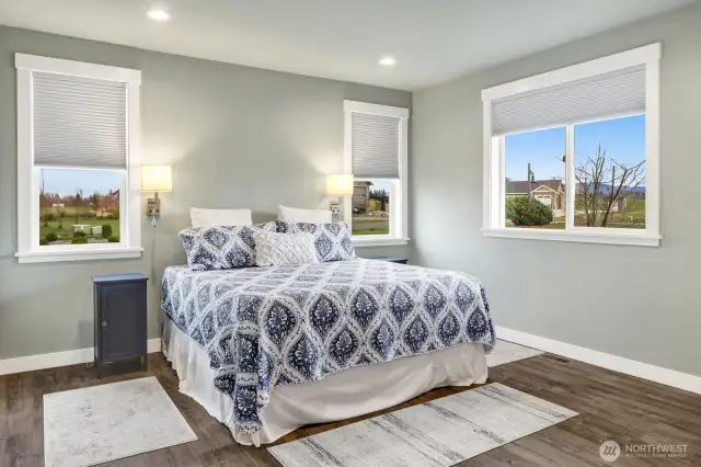 This large bedroom #3 was redesigned in the construction process to be a secondary primary with its own bathroom. Extra windows allow for an extremely bright feeling as seen in the home throughout.