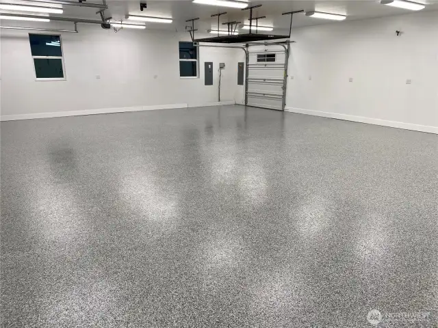 This 1,339 sq ft 3-car garage has all the room needed to store all of your cars, tools, and more! Seen in the back is the pull through door leading you to the exterior outdoor shed building.  And if that isn't enough, this garage even comes complete with BRAND NEW Epoxied floors!
