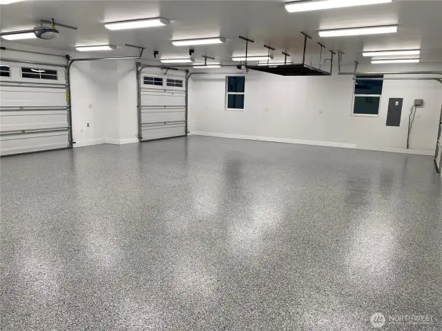The spacious 3-car garage is equipped with extra lighting, creating the perfect environment for any home project, from weekend DIYs to serious craftsmanship.