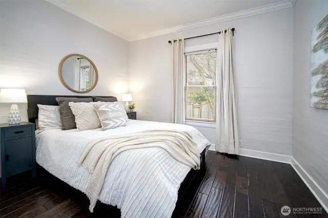 Spacious main floor bedroom just off dining area with closet space and views of the backyard.