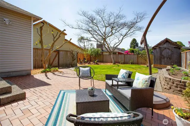 Beautiful brick patio w/path to south side of the house and driveway