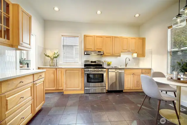 Spacious kitchen with updated sink, backsplash, flooring. Tons of cabinet and counterspace!