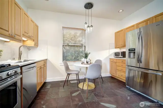 Stainless steel appliances and gas range plus casual eating nook.