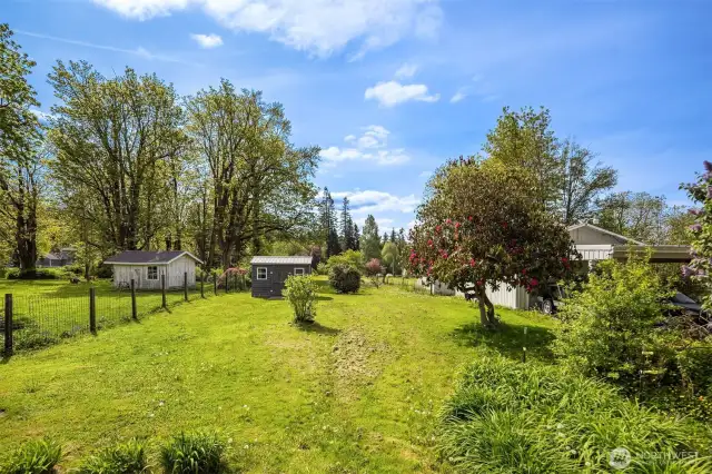 The expansive lot opens endless possibilities: plant your dream flower or vegetable garden, expand the current home, or even build a new home, garage, or shop in the back.