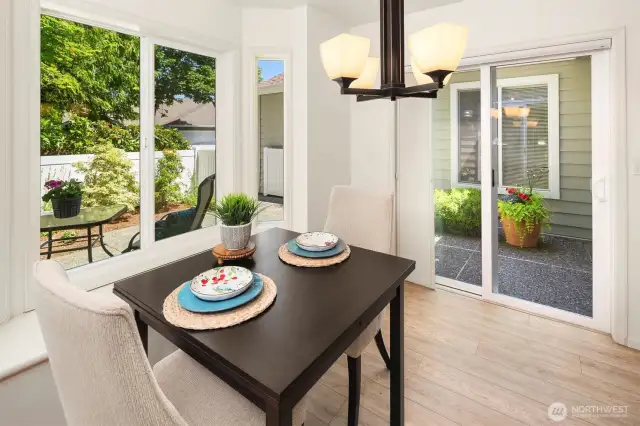 Bright breakfast nook with sliding door to fenced patio.