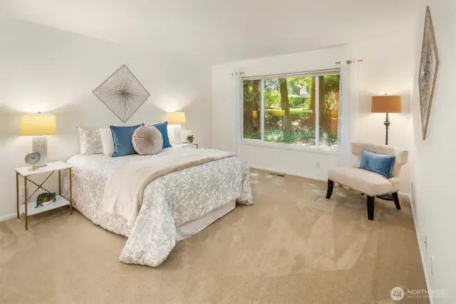 Beautiful primary bedroom with large garden window.