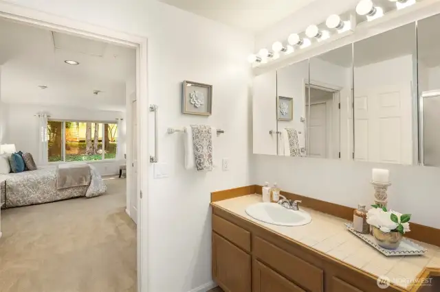 Large primary bathroom with linen closet and step in shower.