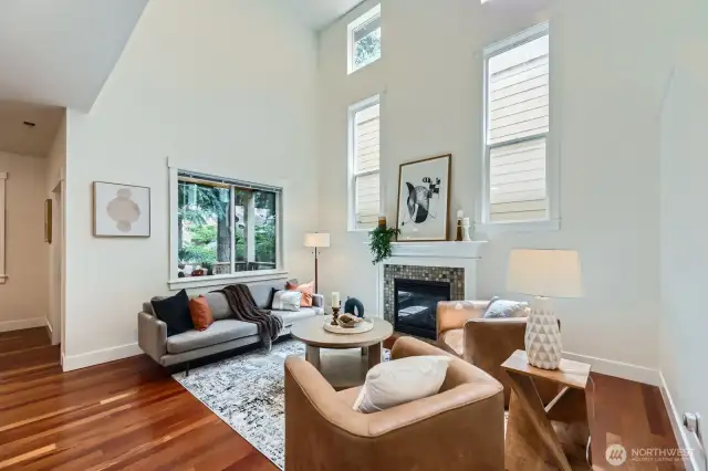 Great room with soaring vaulted ceilings, adjacent deck, hardwoods floors and gas fireplace.