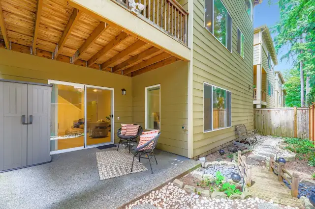 Covered lower level patio and small yard space. Storage shed stays with home.