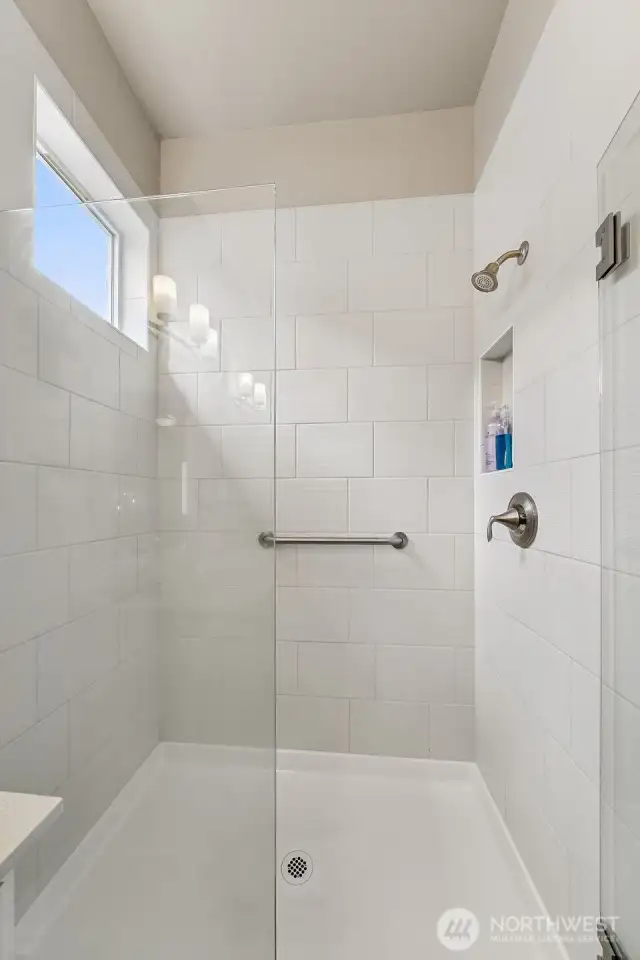 Large, fully tiled shower in primary